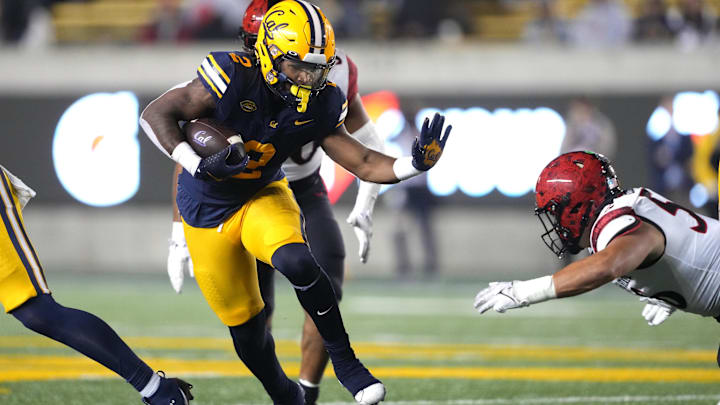 Sep 14, 2024; Berkeley, California, USA; California Golden Bears running back Kadarius Calloway (2) carries the ball against San Diego State Aztecs linebacker DJ Herman (right) during the fourth quarter at California Memorial Stadium. Mandatory Credit: Darren Yamashita-Imagn Images
