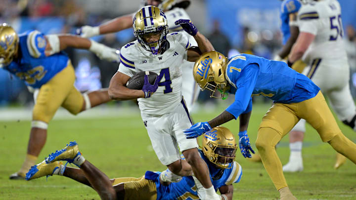 Nov 22, 2025; Pasadena, California, USA; Washington Huskies running back Jordan Washington (4) is stopped by UCLA Bruins defensive back Aaron Williams (7) after a gain of 17 yards and a first down during the second half at the Rose Bowl. Mandatory Credit: Jayne Kamin-Oncea-Imagn Images Nov 22, 2025; Pasadena, California, USA; Washington Huskies running back Jordan Washington (4) is stopped by UCLA Bruins defensive back Aaron Williams (7) after a gain of 17 yards and a first down during the second half at the Rose Bowl. Mandatory Credit: Jayne Kamin-Oncea-Imagn Images
