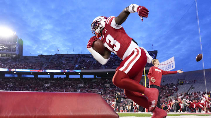 Oct 26, 2024; Madison, Wisconsin, USA;  Wisconsin Badgers running back Darrion Dupree (13) rushes with the football during warmups prior to the game against the Penn State Nittany Lions at Camp Randall Stadium.