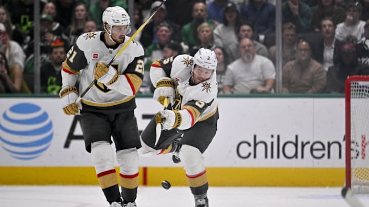 Mar 10, 2026; Dallas, Texas, USA; Vegas Golden Knights defenseman Jeremy Lauzon (5) clears the puck on the Vegas penalty kill as center Brett Howden (21) looks on during the third period against the Dallas Stars at the American Airlines Center. Mandatory Credit: Jerome Miron-Imagn Images