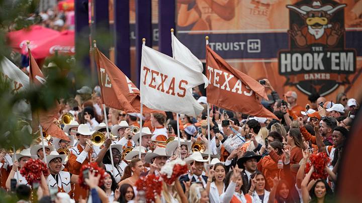 Texas Longhorns flags are carried by the marching band during the Bevo Parade before a game against the Texas A&M Aggies at Darrell K Royal-Texas Memorial Stadium. Texas Longhorns flags are carried by the marching band during the Bevo Parade before a game against the Texas A&M Aggies at Darrell K Royal-Texas Memorial Stadium.