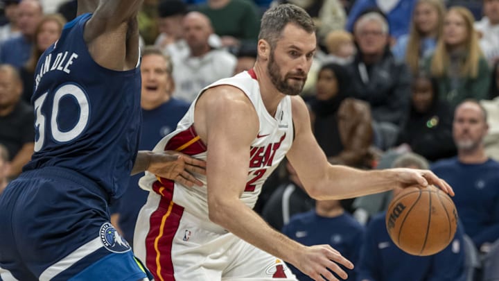 Nov 10, 2024; Minneapolis, Minnesota, USA; Miami Heat forward Kevin Love (42) drives to the basket past Minnesota Timberwolves forward Julius Randle (30) in the second half at Target Center. Mandatory Credit: Jesse Johnson-Imagn Images