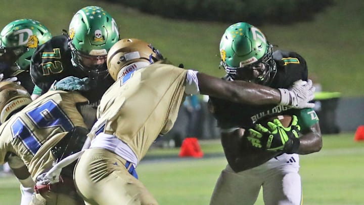 DeLand’s Marceles Carey (1) pushes through players down the field during a game against Mainland earlier this year. Carey last week rushed four times for 164 yards and three touchdowns, and made four tackles and two interceptions, including a pick-6, to lead the unbeaten Bulldogs past St. Johns Creekside, 70-21, in a Class 7A, Region 1 quarterfinal. 