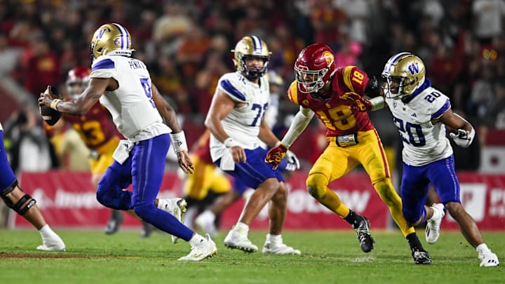 Nov 4, 2023; Los Angeles, California, USA; Washington Huskies quarterback Michael Penix Jr. (9) looks to pass the ball against USC Trojans linebacker Eric Gentry (18) during the fourth quarter at United Airlines Field at Los Angeles Memorial Coliseum. Mandatory Credit: Jonathan Hui-Imagn Images