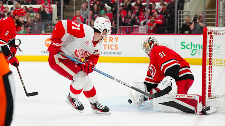 Mar 14, 2025; Raleigh, North Carolina, USA;  Detroit Red Wings center Dylan Larkin (71) scoring attempt is stopped by Carolina Hurricanes goaltender Frederik Andersen (31) during the second period at Lenovo Center. Mandatory Credit: James Guillory-Imagn Images