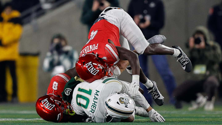 Nov 8, 2025; Fort Collins, Colorado, USA; Colorado State Rams wide receiver Tommy Maher (10) is tackled by UNLV Rebels linebacker Marsel McDuffie (8) and defensive back Andrew Powdrell (4) in the second quarter at Sonny Lubick Field at Canvas Stadium. Nov 8, 2025; Fort Collins, Colorado, USA; Colorado State Rams wide receiver Tommy Maher (10) is tackled by UNLV Rebels linebacker Marsel McDuffie (8) and defensive back Andrew Powdrell (4) in the second quarter at Sonny Lubick Field at Canvas Stadium.