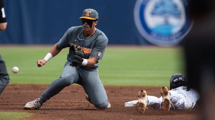 Vanderbilt Commodores' Rustan Rigdon (19) dives safely into second base before Tennessee Volunteer's Dean Curley (1) can get the ball as Vanderbilt Commodores take on Tennessee Volunteer during the SEC baseball tournament at Hoover Met in Birmingham, Ala., on Saturday, May 24, 2025. Vanderbilt Commodores' Rustan Rigdon (19) dives safely into second base before Tennessee Volunteer's Dean Curley (1) can get the ball as Vanderbilt Commodores take on Tennessee Volunteer during the SEC baseball tournament at Hoover Met in Birmingham, Ala., on Saturday, May 24, 2025.