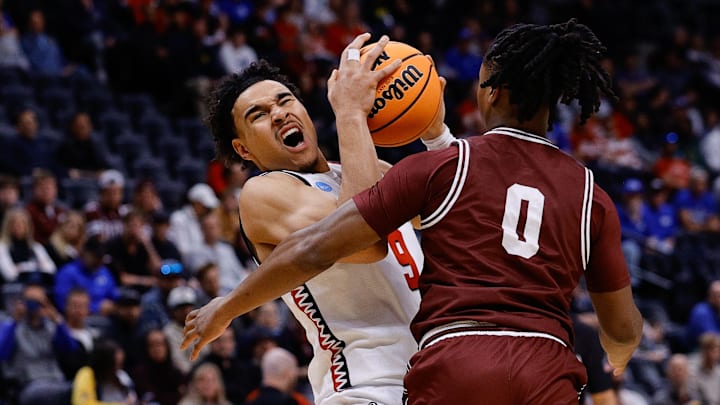 Mar 20, 2025; Denver, CO, USA; Montana Grizzlies guard Money Williams (0) defends against Wisconsin Badgers guard John Tonje (9) during the first half in the first round of the NCAA Tournament at Ball Arena. Mar 20, 2025; Denver, CO, USA; Montana Grizzlies guard Money Williams (0) defends against Wisconsin Badgers guard John Tonje (9) during the first half in the first round of the NCAA Tournament at Ball Arena.