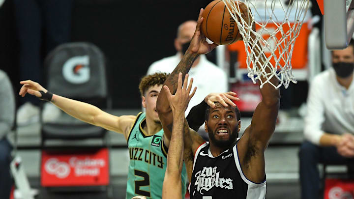 Los Angeles Clippers forward Kawhi Leonard (2) is fouled by Charlotte Hornets guard LaMelo Ball (2) as he goes up for a dunk in the second half of the game at Staples Center. Mandatory Credit: Jayne Kamin-Oncea-Imagn Images