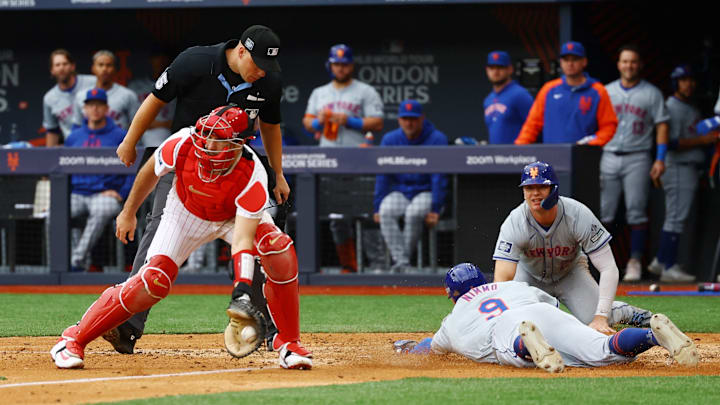 June 9, 2024; London, United Kingdom; New York Mets player Brandon Nimmo scores a run past Philadelphia Phillies catcher J.T. Realmuto during a London Series baseball game at Queen Elizabeth Olympic Park.