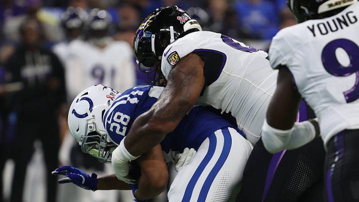 Sep 13, 2026; Indianapolis, Indiana, USA;  Baltimore Ravens defensive line Travis Jones (98) tackles Indianapolis Colts running back Jonathan Taylor (28) during the first quarter at Lucas Oil Stadium.  Mandatory Credit: Trevor Ruszkowski-Imagn Images