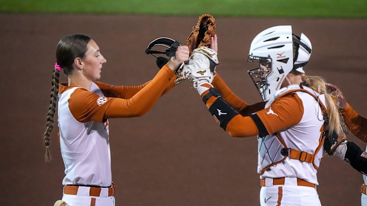 Texas Longhorns pitcher Teagan Kavan (17) greets catcher Reese Atwood (14) at the start of the game against Texas Tech on day one of the Bevo Classic at Red and Charline McCombs Field.