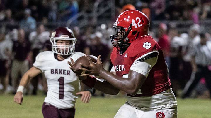 Tiger sophomore Artavious Jones pulls in a pass for a touchdown. Blountstown hosted Baker under the lights for Friday night football October 22, 2021.

023 102221 Blountstown Vs Baker Fb