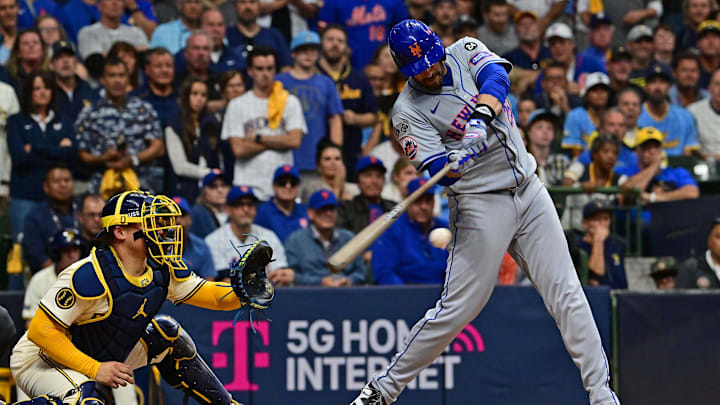 Oct 1, 2024; Milwaukee, Wisconsin, USA; New York Mets designated hitter J.D. Martinez (28) hits a two run single against the Milwaukee Brewers during the fifth inning in game one of the Wildcard round for the 2024 MLB Playoffs at American Family Field. 