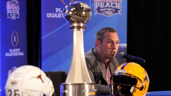Arizona State head coach Kenny Dillingham responds to a question during a joint news conference with Texas head coach Steve Sarkisian before facing off in the Chick-fil-A Peach Bowl.