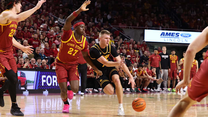Iowa State Cyclones guard Killyan Toure (27) defends Iowa Hawkeyes guard Bennett Stirtz (14)