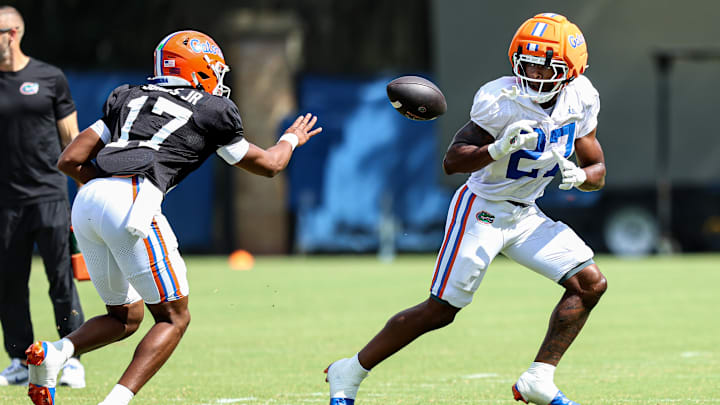 Tramell Jones Jr. pitches the ball to Byron Louis during the viewing period for the Florida Gators fall camp practice on Aug. 5.