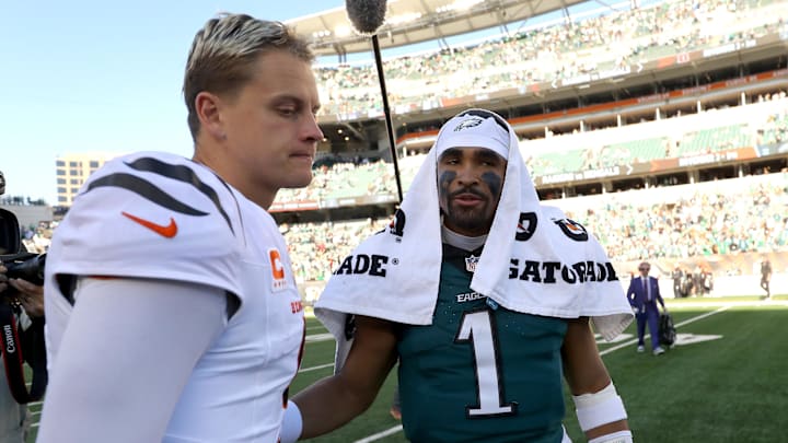 Oct 27, 2024; Cincinnati, Ohio, USA;  Cincinnati Bengals quarterback Joe Burrow (9) and Philadelphia Eagles quarterback Jalen Hurts (1) meet after the game Paycor Stadium. Mandatory Credit: Joseph Maiorana-Imagn Images