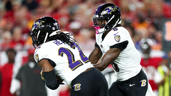 Oct 21, 2024; Tampa, Florida, USA; Baltimore Ravens quarterback Lamar Jackson (8) hands off to running back Derrick Henry (22) against the Tampa Bay Buccaneers in the first quarter at Raymond James Stadium. Mandatory Credit: Nathan Ray Seebeck-Imagn Images