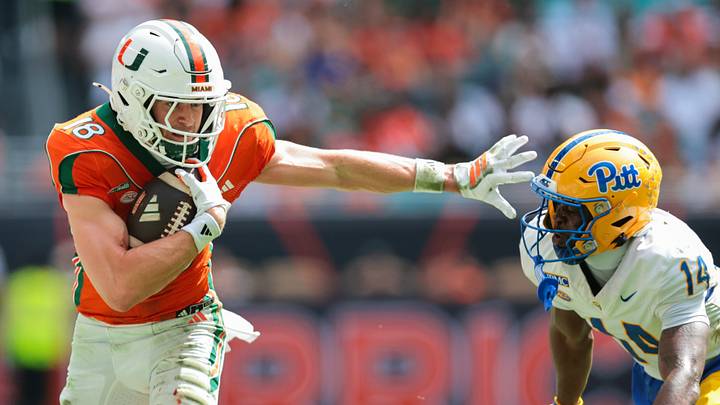 Miami wide receiver Cooper Barkate runs with the football against Pitt defensive back Josh Guerrier. The Hurricanes are the favorite to win the national championship after Week 8. Miami wide receiver Cooper Barkate runs with the football against Pitt defensive back Josh Guerrier. The Hurricanes are the favorite to win the national championship after Week 8.