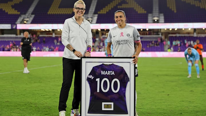 Oct 15, 2023; Orlando, Florida, USA; Orlando Pride forward Marta (10) with general manager Haley Carter during a ceremony to celebrate her 100 appearances after the game against the Houston Dash at Exploria Stadium. Mandatory Credit: Cory Knowlton-Imagn Images