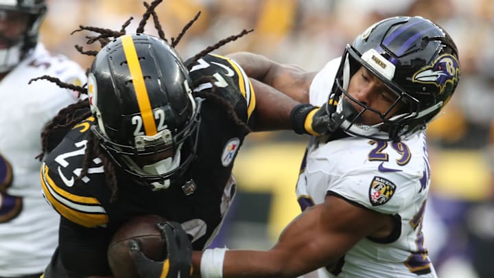 Nov 17, 2024; Pittsburgh, Pennsylvania, USA;  Pittsburgh Steelers running back Najee Harris (22) carries the ball against Baltimore Ravens safety Ar'Darius Washington (29) during the fourth quarter at Acrisure Stadium. Mandatory Credit: Charles LeClaire-Imagn Images