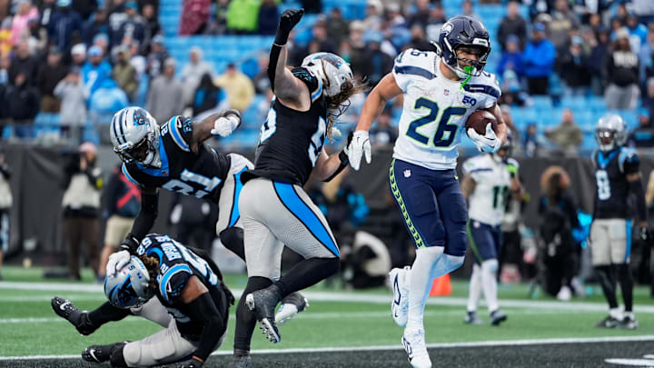 Dec 28, 2025; Charlotte, North Carolina, USA; Seattle Seahawks running back Zach Charbonnet (26) scores a two-yard rushing touchdown against the Carolina Panthers during the fourth quarter at Bank of America Stadium. Mandatory Credit: Jim Dedmon-Imagn Images