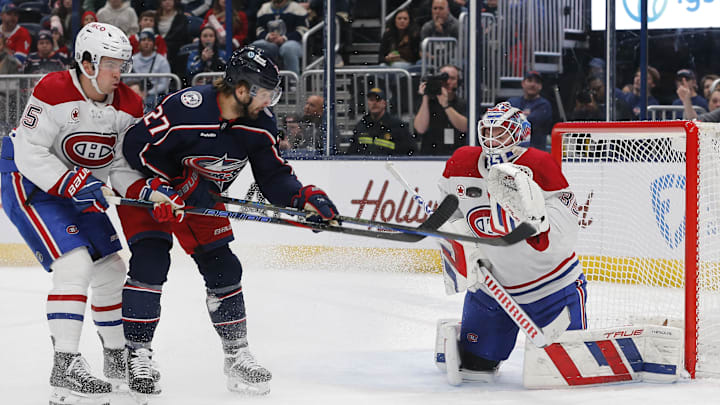 Dec 23, 2024; Columbus, Ohio, USA; Montreal Canadiens goalie Sam Montembeault (35) makes a save as Columbus Blue Jackets center Zach Aston-Reese (27) looks for a rebound during the second period at Nationwide Arena. Mandatory Credit: Russell LaBounty-Imagn Images