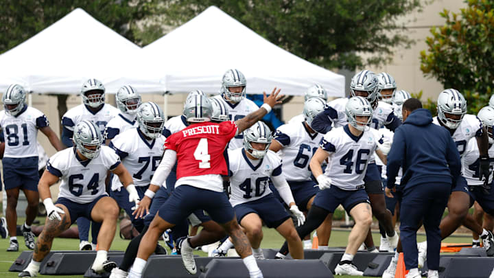 Dallas Cowboys quarterback Dak Prescott leads teammates through a drill at the Ford Center at the Star Training Facility.