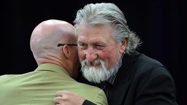 Former Zips basketball coach Bob Huggins, facing, hugs current coach John Groce after speaking during the Akron Basketball reunion and celebration at the University of Akron student union, Saturday, July 27, 2024, in Akron, Ohio. Former Zips basketball coach Bob Huggins, facing, hugs current coach John Groce after speaking during the Akron Basketball reunion and celebration at the University of Akron student union, Saturday, July 27, 2024, in Akron, Ohio.
