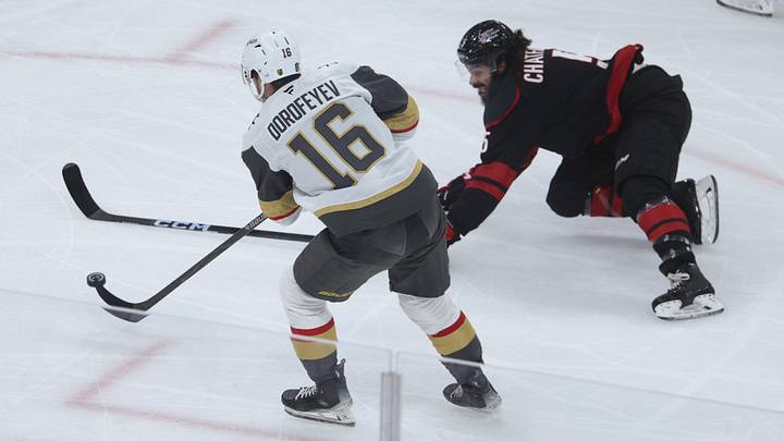 Jun 2, 2026; Raleigh, North Carolina, USA; Carolina Hurricanes defenseman Jalen Chatfield (5) reaches for the puck a- Vegas Golden Knights right wing Pavel Dorofeyev (16) during the first period in game one of the 2026 Stanley Cup Final at Lenovo Center. 