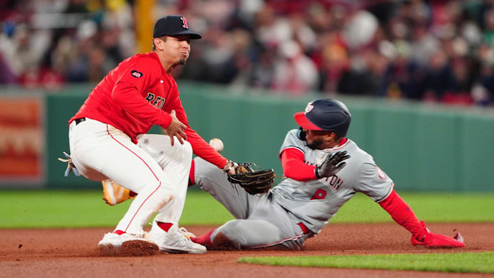 May 10, 2024; Boston, Massachusetts, USA; Washington Nationals left fielder Eddie Rosario (8) steals second base with Boston Red Sox second baseman Vaughn Grissom (5) attempting to catch a throw during the ninth inning at Fenway Park. Mandatory Credit: Gregory Fisher-Imagn Images