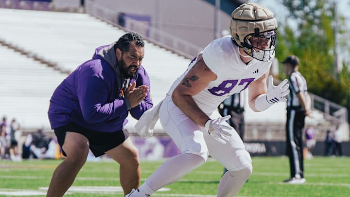 TE coach Jordan Paopao encourages Ryan Otton during spring ball.