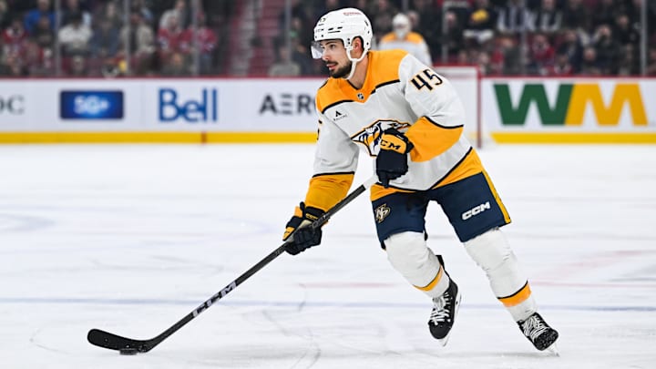 Dec 5, 2024; Montreal, Quebec, CAN; Nashville Predators defenseman Alexandre Carrier (45) plays the puck against the Montreal Canadiens  during the third period at Bell Centre. Mandatory Credit: David Kirouac-Imagn Images