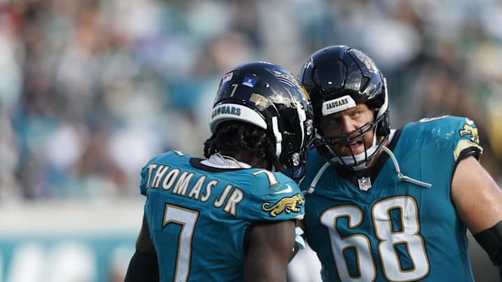 Dec 15, 2024; Jacksonville, Florida, USA; Jacksonville Jaguars wide receiver Brian Thomas Jr. (7) and offensive line Brandon Scherff (68) celebrate a touchdown against the New York Jets during the fourth quarter at EverBank Stadium. Mandatory Credit: Morgan Tencza-Imagn Images