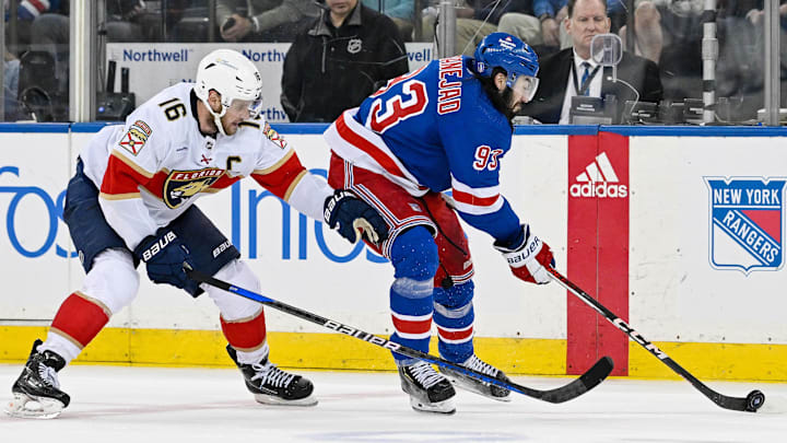 May 30, 2024; New York, New York, USA; New York Rangers center Mika Zibanejad (93) passes the puck as New York Rangers center Vincent Trocheck (16) defends during the third period in game five of the Eastern Conference Final of the 2024 Stanley Cup Playoffs at Madison Square Garden. Mandatory Credit: Dennis Schneidler-USA TODAY Sports