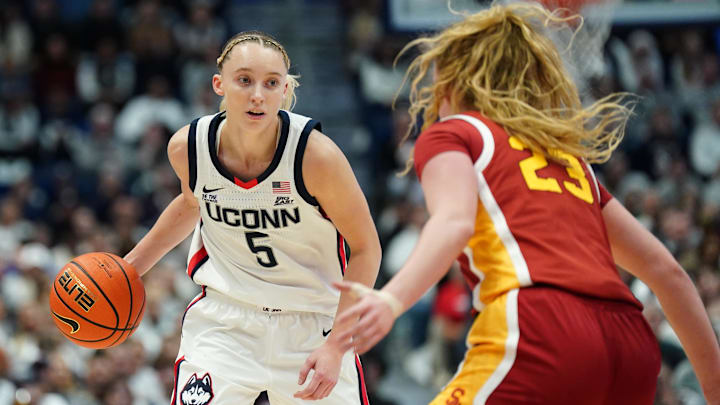 Dec 21, 2024; Hartford, Connecticut, USA; UConn Huskies guard Paige Bueckers (5) moves the ball against USC Trojans guard Avery Howell (23) in the first half at XL Center. Mandatory Credit: David Butler II-Imagn Images Dec 21, 2024; Hartford, Connecticut, USA; UConn Huskies guard Paige Bueckers (5) moves the ball against USC Trojans guard Avery Howell (23) in the first half at XL Center. Mandatory Credit: David Butler II-Imagn Images