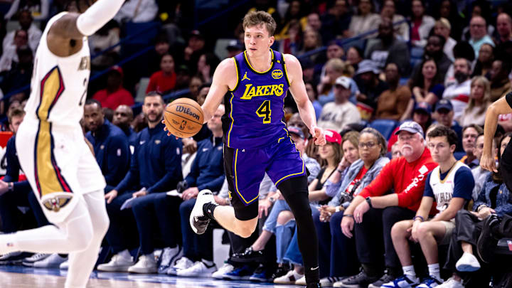 Nov 16, 2024; New Orleans, Louisiana, USA; Los Angeles Lakers guard Dalton Knecht (4) brings the ball up court against the New Orleans Pelicans during the first half at Smoothie King Center. Mandatory Credit: Stephen Lew-Imagn Images