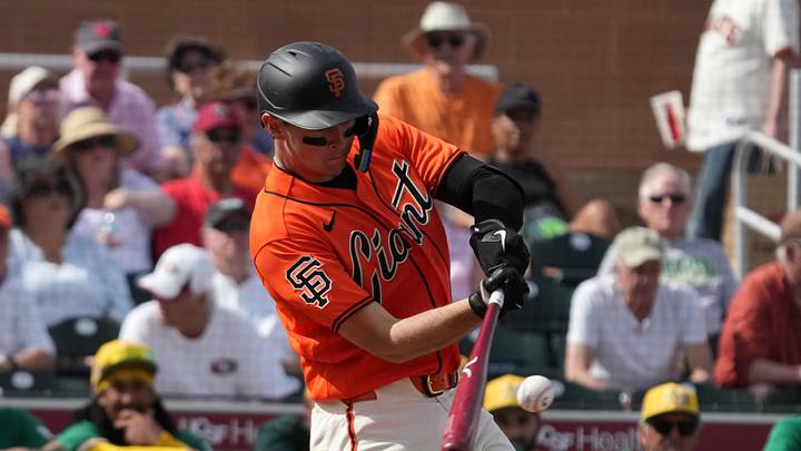 Feb 23, 2026; Scottsdale, Arizona, USA; San Francisco Giants catcher Daniel Susac (6) hits a single against the Athletics in the third inning at Scottsdale Stadium. Mandatory Credit: Rick Scuteri-Imagn Images