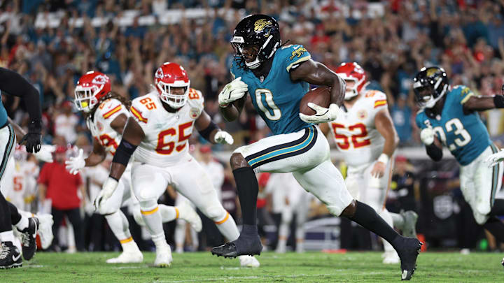 Jacksonville Jaguars linebacker Devin Lloyd intercepts a pass and returns it for a touchdown during
