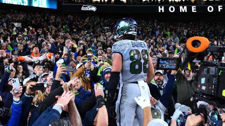 Dec 18, 2025; Seattle, Washington, USA; Seattle Seahawks tight end AJ Barner (88) celebrates with fans after a win against the Los Angeles Rams in overtime at Lumen Field.