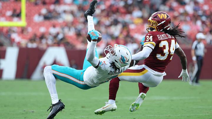 Aug 14, 2026; Landover, Maryland, USA; Miami Dolphins wide receiver Caleb Douglas (7) reaches for a pass as Washington Commanders cornerback Antonio Hamilton Sr. (34) defends during the first half at Northwest Stadium. Mandatory Credit: Amber Searls-Imagn Images Aug 14, 2026; Landover, Maryland, USA; Miami Dolphins wide receiver Caleb Douglas (7) reaches for a pass as Washington Commanders cornerback Antonio Hamilton Sr. (34) defends during the first half at Northwest Stadium. Mandatory Credit: Amber Searls-Imagn Images