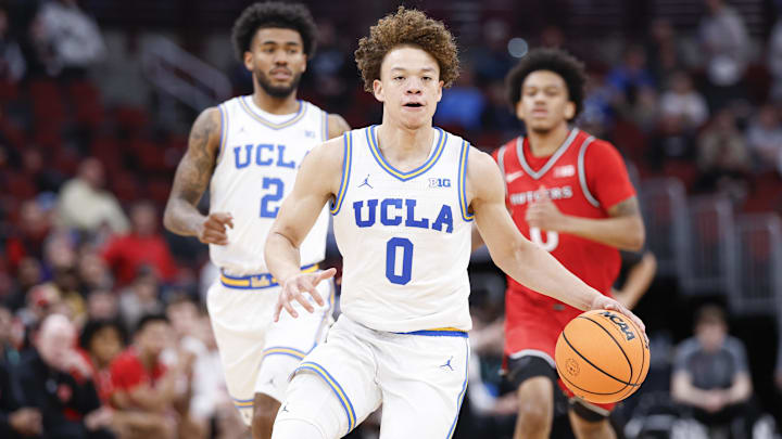 Mar 12, 2026; Chicago, IL, USA; UCLA Bruins guard Trent Perry (0) brings the ball up court against the Rutgers Scarlet Knights during the second half at United Center. Mandatory Credit: Kamil Krzaczynski-Imagn Images