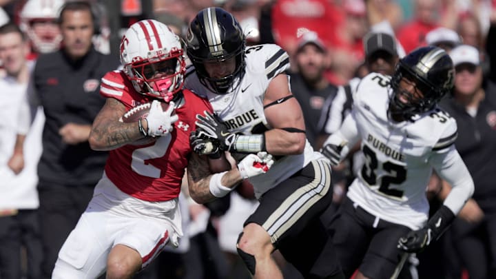 Wisconsin wide receiver Trech Kekahuna (2) being shoved out of bounds by Purdue defensive back Dillon Thieneman (31)
