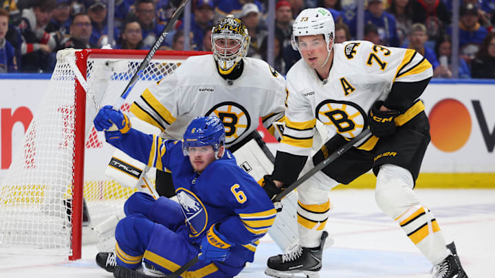 Apr 19, 2026; Buffalo, New York, USA; Boston Bruins defenseman Charlie McAvoy (73) knocks down Buffalo Sabres left wing Zach Benson (6) in front of the net as Boston Bruins goaltender Jeremy Swayman (1) watches the puck during the second period in game one of the first round of the 2026 Stanley Cup Playoffs at KeyBank Center. Mandatory Credit: Timothy T. Ludwig-Imagn Images