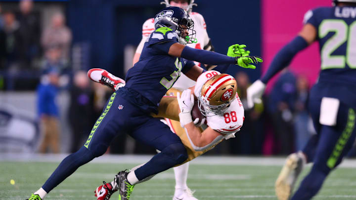 San Francisco 49ers tight end Jake Tonges (88) is tackled by Seattle Seahawks safety Nick Emmanwori (3).