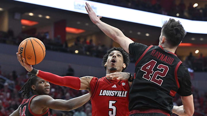 Mar 8, 2025; Louisville, Kentucky, USA;  Louisville Cardinals guard Terrence Edwards Jr. (5) shoots against Stanford Cardinal forward Maxime Raynaud (42) and forward Jaylen Thompson (24) during the second half at KFC Yum! Center. Louisville defeated Stanford 68-48. Mandatory Credit: Jamie Rhodes-Imagn Images