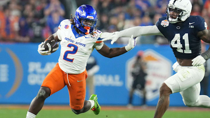 Boise State Broncos running back Ashton Jeanty runs past Penn State Nittany Lions linebacker Kobe King.