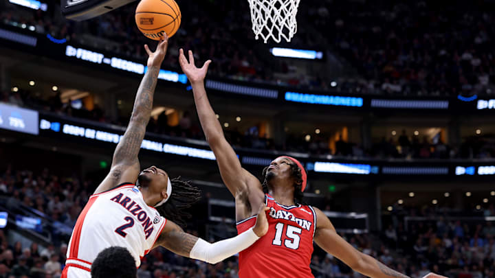 Mar 23, 2024; Salt Lake City, UT, USA; Arizona Wildcats guard Caleb Love (2) and Dayton Flyers forward DaRon Holmes II (15) fight for a rebound during the second half in the second round of the 2024 NCAA Tournament at Vivint Smart Home Arena-Delta Center. Mandatory Credit: Rob Gray-USA TODAY Sports