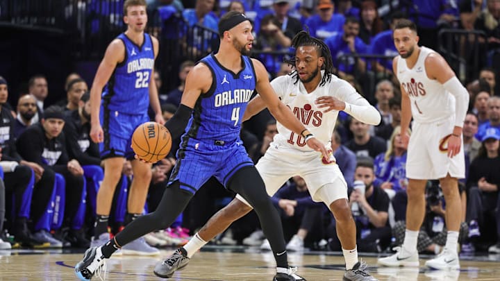 Orlando Magic guard Jalen Suggs (4) passes the ball in front of Cleveland Cavaliers guard Darius Garland (10) during the first quarter of game six of the first round for the 2024 NBA playoffs at Kia Center. 